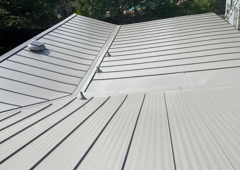 Solar attic fan installed on a metal roof for Roof Ventilation in Travis Ranch